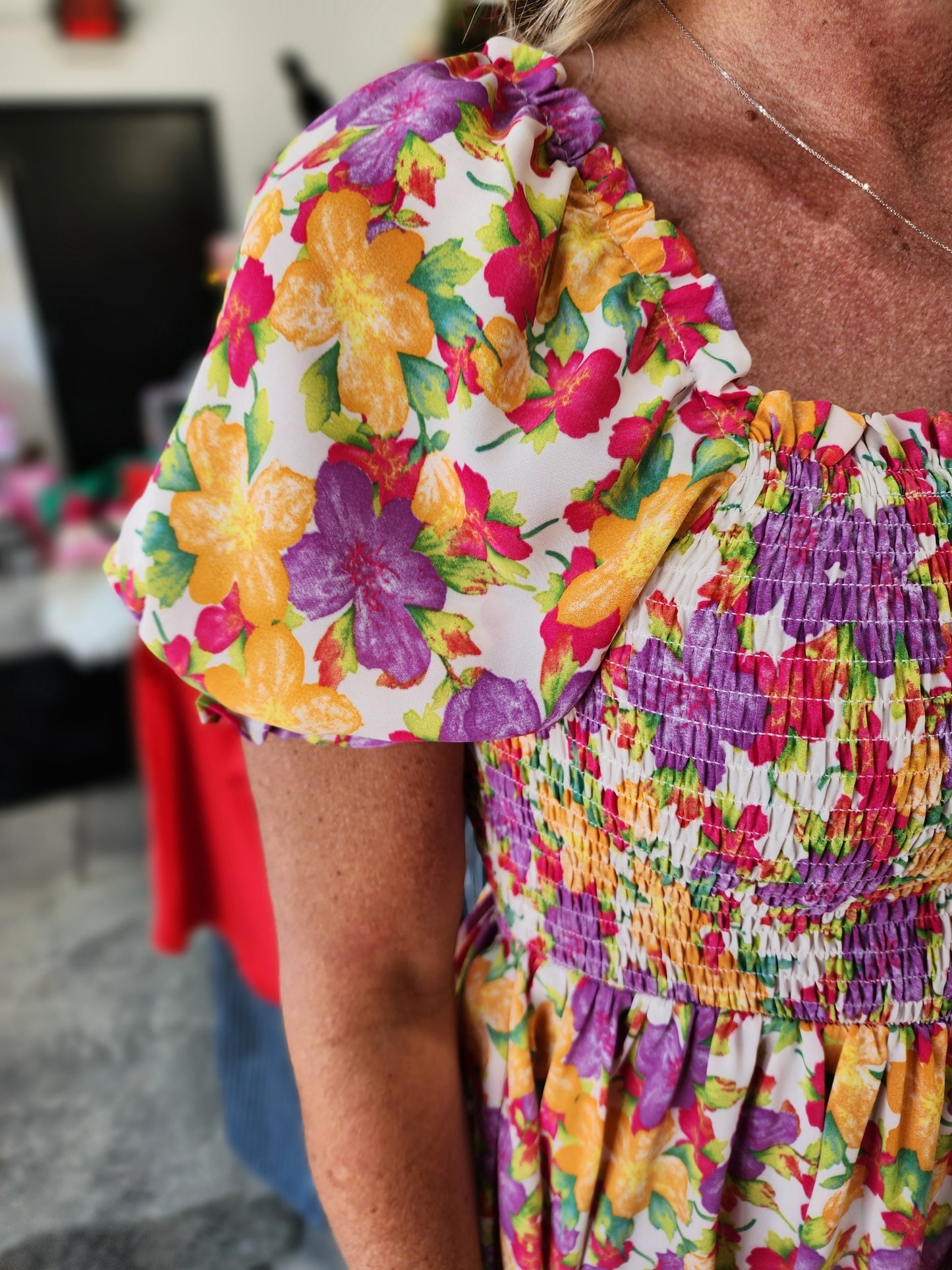 Close-up of colorful floral-patterned gloves and a multicolored fabric.